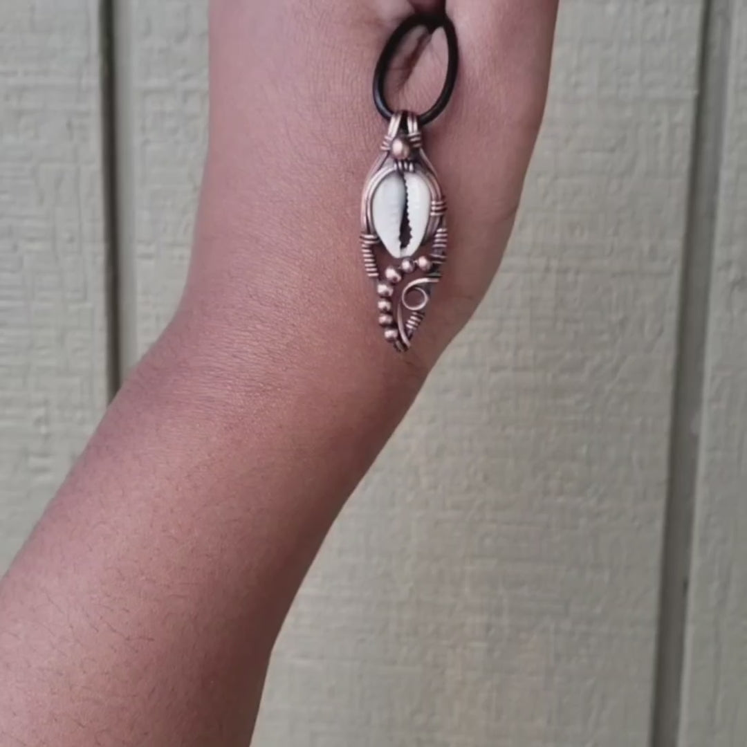 Load and play video in Gallery viewer, Cowrie Shell in Solid Copper Pendant