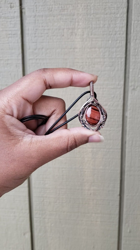 Load and play video in Gallery viewer, Red Tigers Eye in Solid Copper Pendant
